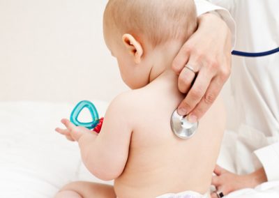 Children's doctor exams infant with stethoscope